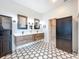 Bright bathroom featuring dual vanities, modern mirrors, and contrasting cabinetry at 15865 Bradicks Ct, Clermont, FL 34711