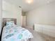 Bright bedroom with coastal-themed bedding, a dresser, and neutral-toned walls at 15865 Bradicks Ct, Clermont, FL 34711