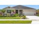 Charming single-story home with a well-manicured lawn and colorful landscaping at 15865 Bradicks Ct, Clermont, FL 34711