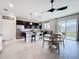 Open kitchen with stainless steel appliances, dark cabinets, and an adjacent dining area at 15865 Bradicks Ct, Clermont, FL 34711