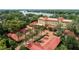 Beautiful aerial view showcasing a home with tile roof, palm trees, and circular driveway by the water at 1602 Alabama Dr # Ph404, Winter Park, FL 32789