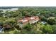Scenic aerial shot of a lakeside home with a beautiful pool and surrounding greenery at 1602 Alabama Dr # Ph404, Winter Park, FL 32789