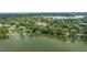 Picturesque aerial view of a lakeside property with lush greenery and private boat access at 1602 Alabama Dr # Ph404, Winter Park, FL 32789