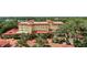 An aerial view of a stately home with a red tile roof, surrounded by trees and a circular driveway at 1602 Alabama Dr # Ph404, Winter Park, FL 32789