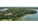 Breathtaking aerial view of a grand lakeside estate surrounded by lush greenery, offering privacy and serenity at 1602 Alabama Dr # Ph404, Winter Park, FL 32789