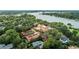 Picturesque aerial of a lakeside property with lush greenery, trees, and charming houses nearby at 1602 Alabama Dr # Ph404, Winter Park, FL 32789