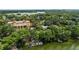 Breathtaking aerial view of a luxurious lakeside property with a dock and well-manicured grounds at 1602 Alabama Dr # Ph404, Winter Park, FL 32789