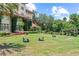 Expansive backyard featuring a lush green lawn, mature trees, and outdoor seating for relaxation at 1602 Alabama Dr # Ph404, Winter Park, FL 32789