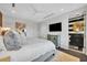 Spacious bedroom featuring a modern bed and a view into the bathroom at 1602 Alabama Dr # Ph404, Winter Park, FL 32789