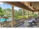 Picturesque view from a covered porch with columns overlooking a lush garden and swimming pool at 1602 Alabama Dr # Ph404, Winter Park, FL 32789