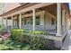 Elegant covered porch featuring classic columns, a cozy seating area, and lush landscaping at 1602 Alabama Dr # Ph404, Winter Park, FL 32789