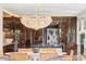 Bright dining area featuring a modern chandelier, stylish chairs, and dark wood cabinets at 1602 Alabama Dr # Ph404, Winter Park, FL 32789