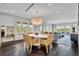 Open concept living and dining area with scenic views and dark wood floors at 1602 Alabama Dr # Ph404, Winter Park, FL 32789