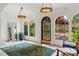Elegant entryway featuring arched windows, custom lighting and tile floors with a large green rug at 1602 Alabama Dr # Ph404, Winter Park, FL 32789