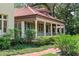 Inviting home exterior with lush landscaping, brick walkway, and a charming covered porch at 1602 Alabama Dr # Ph404, Winter Park, FL 32789