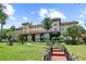 Grand building exterior showcasing lush landscaping, and a well-manicured lawn on a sunny day at 1602 Alabama Dr # Ph404, Winter Park, FL 32789