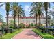Stately building with red tiled roof, palm trees and inviting walkway at 1602 Alabama Dr # Ph404, Winter Park, FL 32789