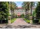 Scenic view of the building entrance, highlighted by palm trees and manicured landscaping at 1602 Alabama Dr # Ph404, Winter Park, FL 32789