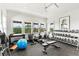 Bright and open home gym space featuring various exercise machines, weights, and natural light from large windows at 1602 Alabama Dr # Ph404, Winter Park, FL 32789