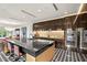 Contemporary kitchen with center island, stainless steel appliances, and adjacent dining area at 1602 Alabama Dr # Ph404, Winter Park, FL 32789