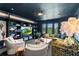 A well-appointed living room with custom bookshelves, a large TV, and stylish decor and lighting at 1602 Alabama Dr # Ph404, Winter Park, FL 32789