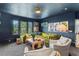 Living room featuring stylish furniture, bright decor, and large windows offering lush green views at 1602 Alabama Dr # Ph404, Winter Park, FL 32789