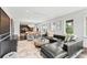Open concept living room and dining area with stylish furniture, dark wood floors, and artful decor at 1602 Alabama Dr # Ph404, Winter Park, FL 32789