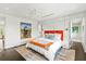 Bright main bedroom featuring white walls, an orange headboard, and art at 1602 Alabama Dr # Ph404, Winter Park, FL 32789