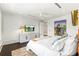 Bright main bedroom featuring white walls, an orange headboard, and TV at 1602 Alabama Dr # Ph404, Winter Park, FL 32789