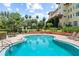 Refreshing swimming pool with outdoor seating, lounge chairs, and manicured landscaping in view at 1602 Alabama Dr # Ph404, Winter Park, FL 32789