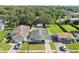 Aerial view of a charming home with a well-manicured lawn, detached garage, and fenced backyard at 1623 Cumbie Ave, Orlando, FL 32804