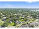 Wide aerial perspective of neighborhood with mature trees, lakes, manicured lawns, and neighborhood streets at 1623 Cumbie Ave, Orlando, FL 32804