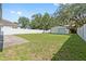 Expansive backyard featuring a detached garage and white fencing at 1623 Cumbie Ave, Orlando, FL 32804