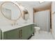 Bathroom featuring double sinks, decorative mirrors, and shower with decorative tile at 1623 Cumbie Ave, Orlando, FL 32804