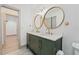 Bathroom featuring double sinks, decorative mirrors, modern fixtures and flooring at 1623 Cumbie Ave, Orlando, FL 32804