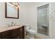 Bathroom featuring decorative sink and mirror, a shower with glass doors and a toilet at 1623 Cumbie Ave, Orlando, FL 32804