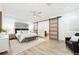 This bedroom features a ceiling fan, sliding barn door, and wood-look floors at 1623 Cumbie Ave, Orlando, FL 32804