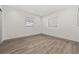 Bedroom with laminated flooring, fresh paint, base trim and multiple windows at 1623 Cumbie Ave, Orlando, FL 32804