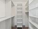 Walk in closet with wood floor and white shelves and hanging rods at 1623 Cumbie Ave, Orlando, FL 32804