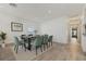 Modern dining room featuring a black table, green chairs, light hardwood floors, and bright lighting at 1623 Cumbie Ave, Orlando, FL 32804
