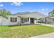 Inviting single-story home with a covered carport, dark shutters, and a well-manicured front yard at 1623 Cumbie Ave, Orlando, FL 32804