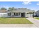 Charming single-story home featuring a cozy porch swing and carport at 1623 Cumbie Ave, Orlando, FL 32804