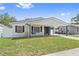 Charming single-story home featuring a cozy porch swing and carport at 1623 Cumbie Ave, Orlando, FL 32804