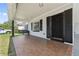 Inviting front porch with tiled flooring, a cozy porch swing, and a secure front door at 1623 Cumbie Ave, Orlando, FL 32804