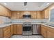 Well-lit kitchen featuring wooden cabinets, granite countertops, and stainless steel appliances at 1623 Cumbie Ave, Orlando, FL 32804