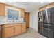 Bright kitchen featuring stainless steel appliances, wood cabinets, and granite countertops at 1623 Cumbie Ave, Orlando, FL 32804