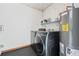 Modern laundry room with new washer and dryer next to the water heater at 1623 Cumbie Ave, Orlando, FL 32804