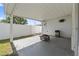 Covered patio featuring a concrete floor, fan, and white brick walls at 1623 Cumbie Ave, Orlando, FL 32804