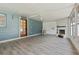 Bright and airy sunroom with blue accent wall, brick fireplace, and natural light at 1623 Cumbie Ave, Orlando, FL 32804