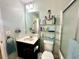 Bathroom features a vanity, toilet, and a shower/tub with glass door at 16334 Saint Augustine St, Clermont, FL 34714